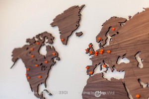 Wooden magnetic world map Walnut in office - close-up