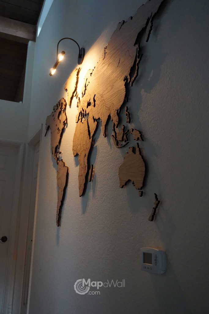 Wooden world map Oak with spotlight by night