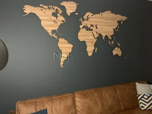 A Zebrano world map installed on a black coloured wall