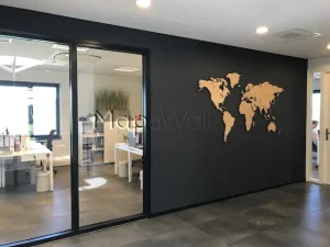 The magnetic Oak wooden world map installed on a black office wall