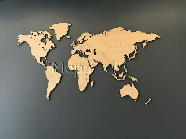 A European Oak magnetic wooden world map installed on black wall