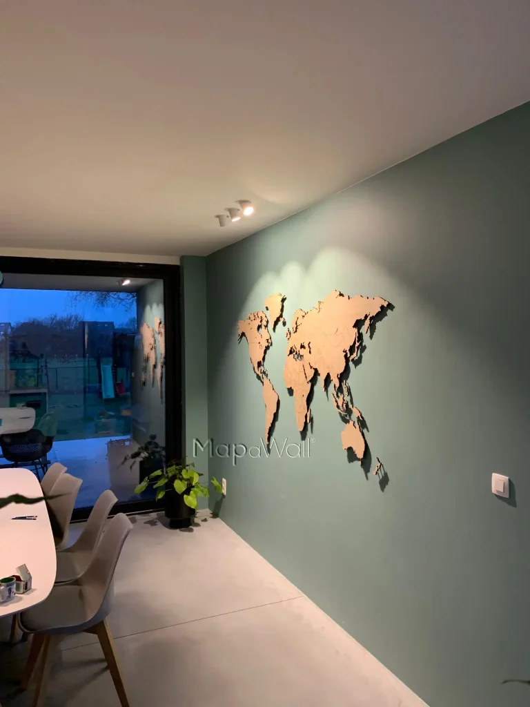 The European Oak wooden world map installed on a light green wall - side view